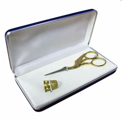 Case with golden stork scissors and thimble