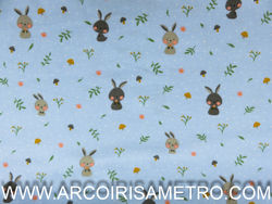 PRINTED FLANNEL WITH BUNNIES ON A BLUE BACKGROUND